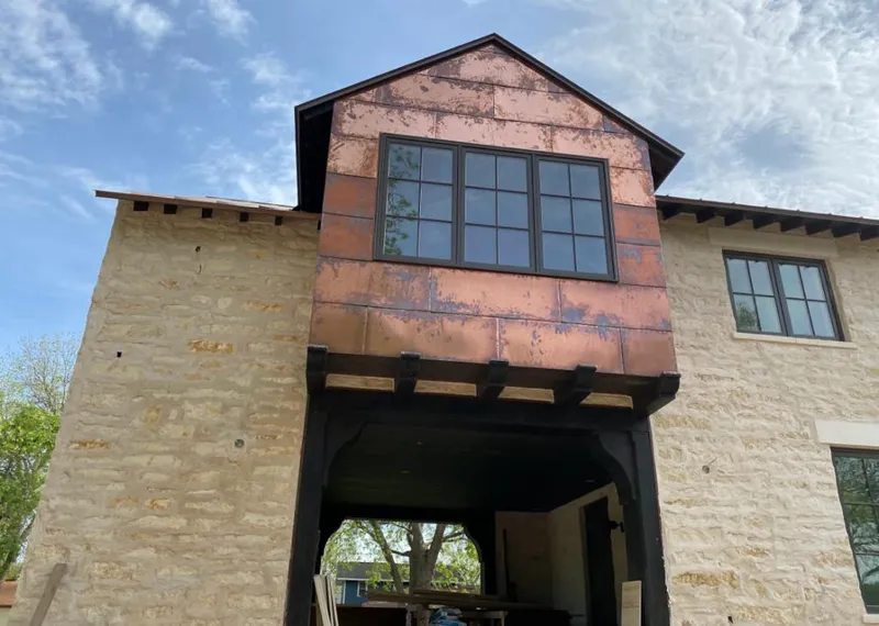 Copper metal panel facade on a stone building for Roof Repair in Oakhurst
