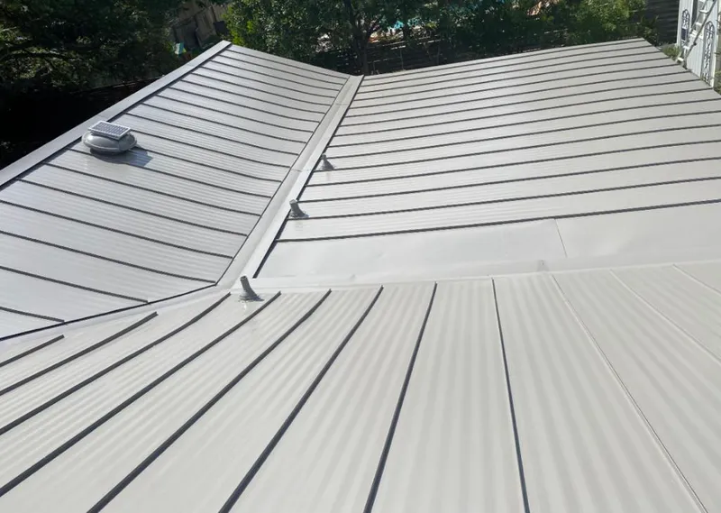 Solar attic fan installed on a metal roof for Roof Ventilation in Oakhurst