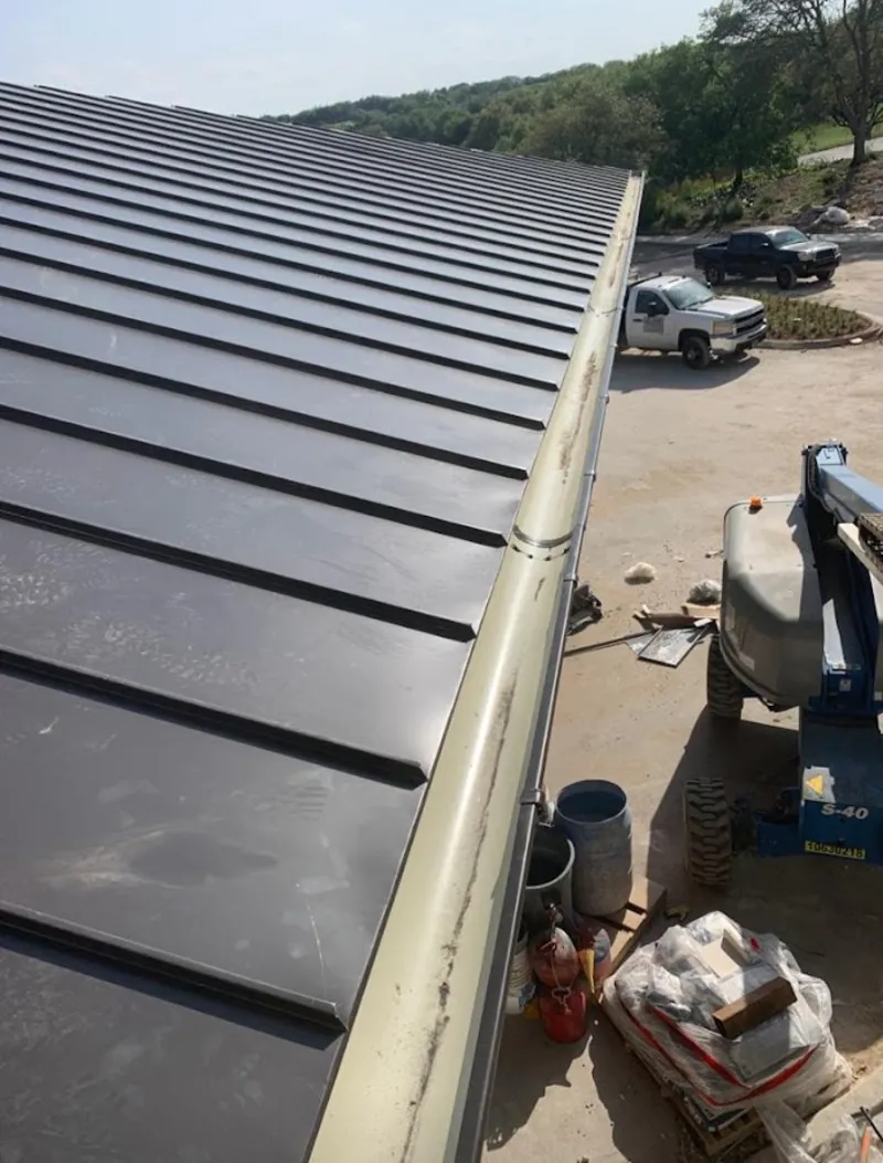 Standing seam panel and gutter detail on a metal roofing jobsite in Oakhurst